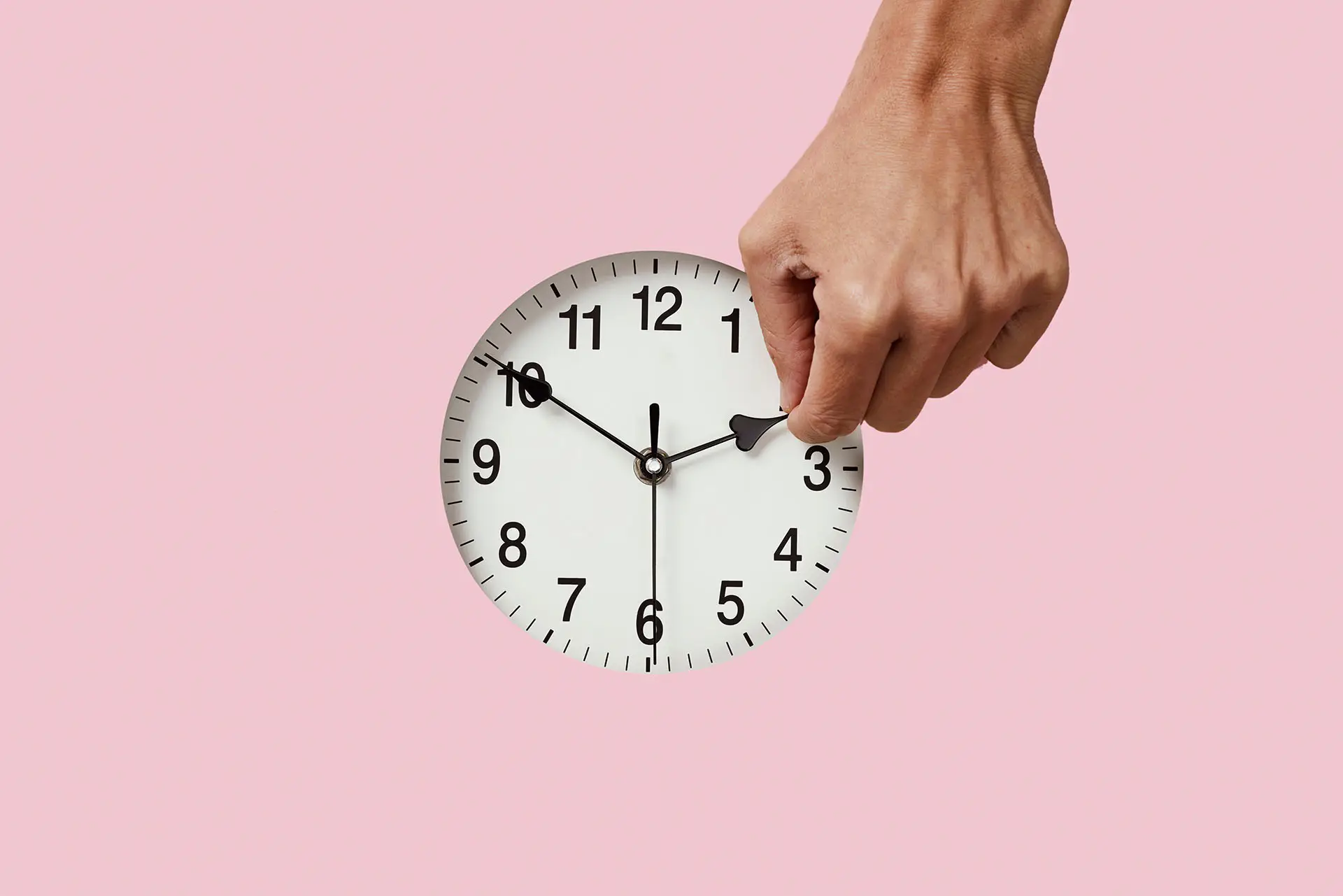 Facebook Moves Time, this image shows a pink background with a clock and a hand moving time