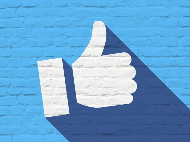 Facebook UK Population graphic shows a brick wall painted blue with a white thumbs up - facebook concept