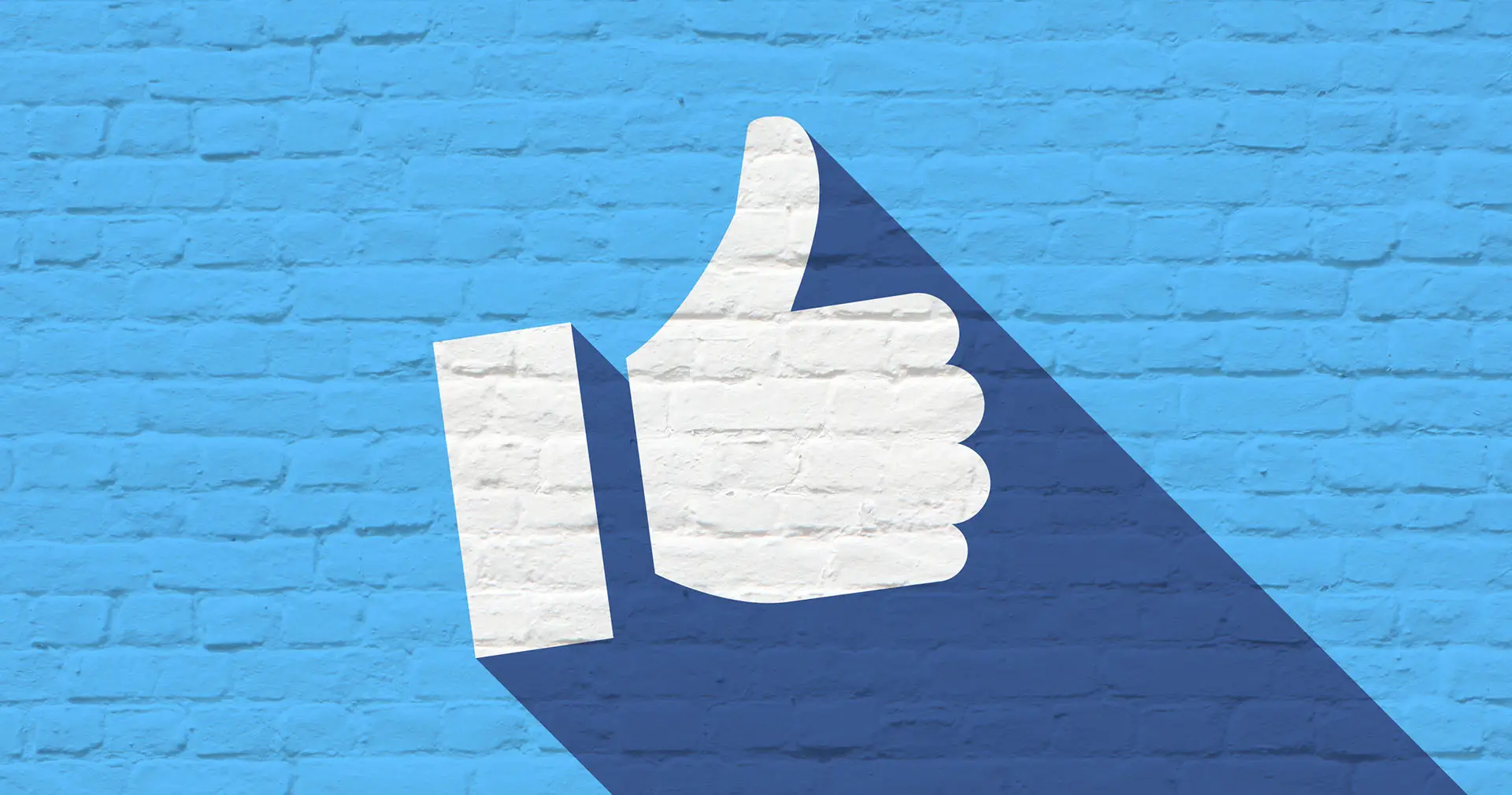 Facebook UK Population graphic shows a brick wall painted blue with a white thumbs up - facebook concept