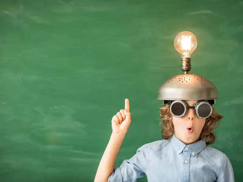 Five Ways to Improve Your Sales Performance this image shows a green background with a young lad with a metal helmet and a light light bulb, concept for sharing Five Ways to Improve Your Sales Performance