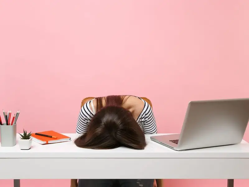 Google+ Is It Worth The Effort? This image shows a young lady with her head resting on her desk - Concept for asking is Google+ worth it?