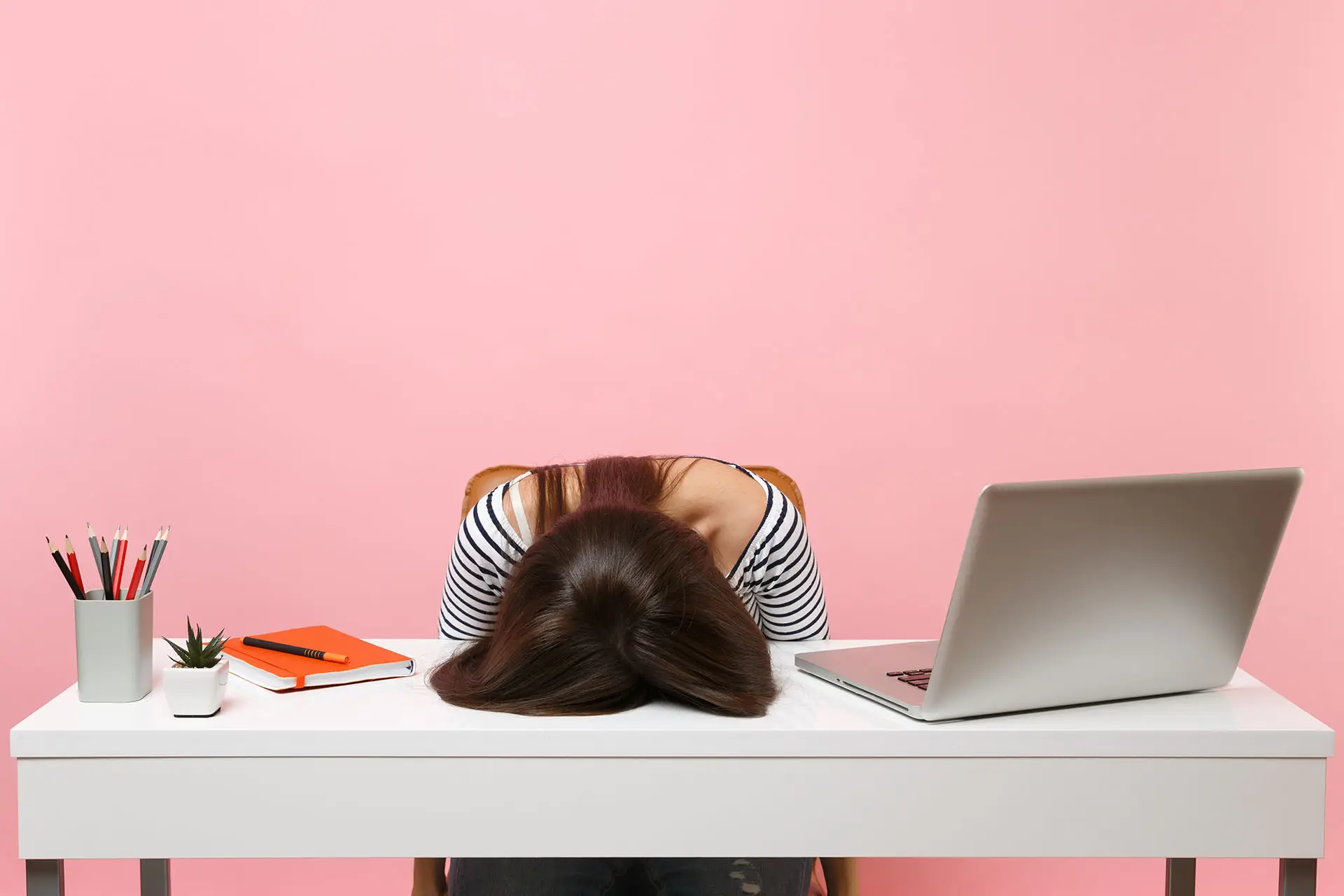 Google+ Is It Worth The Effort? This image shows a young lady with her head resting on her desk - Concept for asking is Google+ worth it?