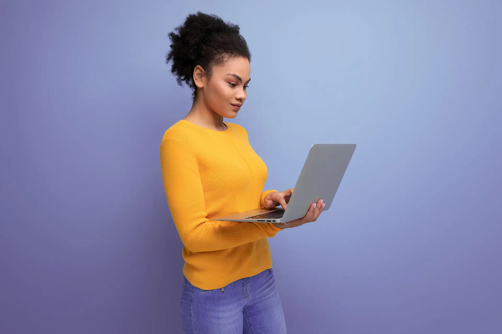 How to Write a Good Call to Action, the image shows a young lady in a yellow jumper holding a laptop and staring at it intently, the image has a lilac background.