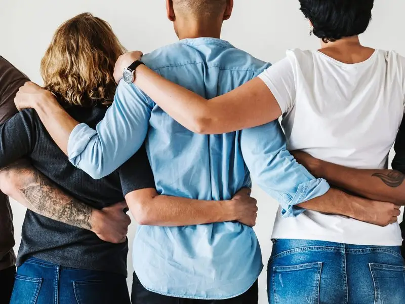 Joined Up Business Development - the image shows a diverse range of colleagues all linked with arms around each other - concept for joined up business development