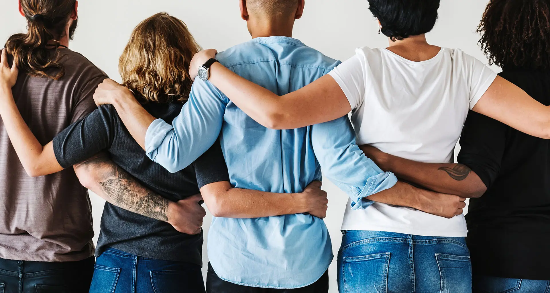 Joined Up Business Development - the image shows a diverse range of colleagues all linked with arms around each other - concept for joined up business development