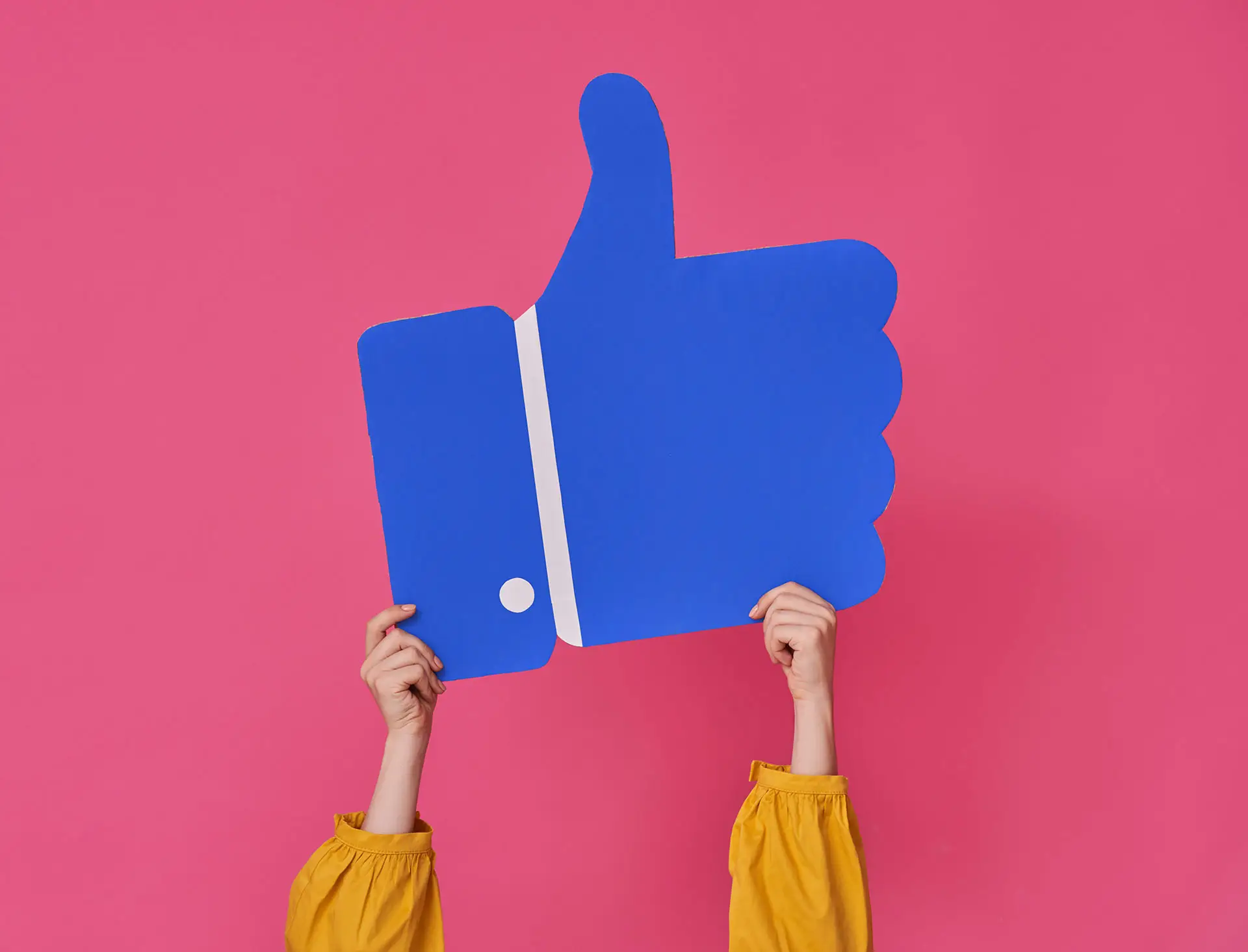 Managing Facebook Enquiries - Image shows a vivd pink background with female arms holding up a big blue thumbs up - Facebook enquiry concept