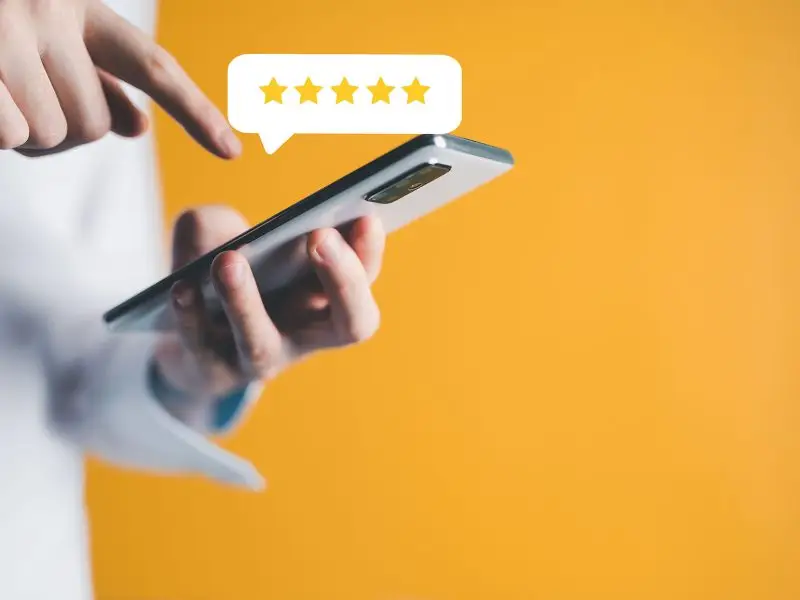 Precious, Precious Reviews image shows a mobile phone and a user with 5 stars in a speech bubble - Review concept