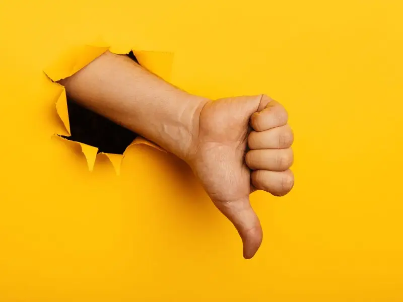 Social Media Warning image shows a thumbs down hand and arm coming out of a bright yellow paper wall