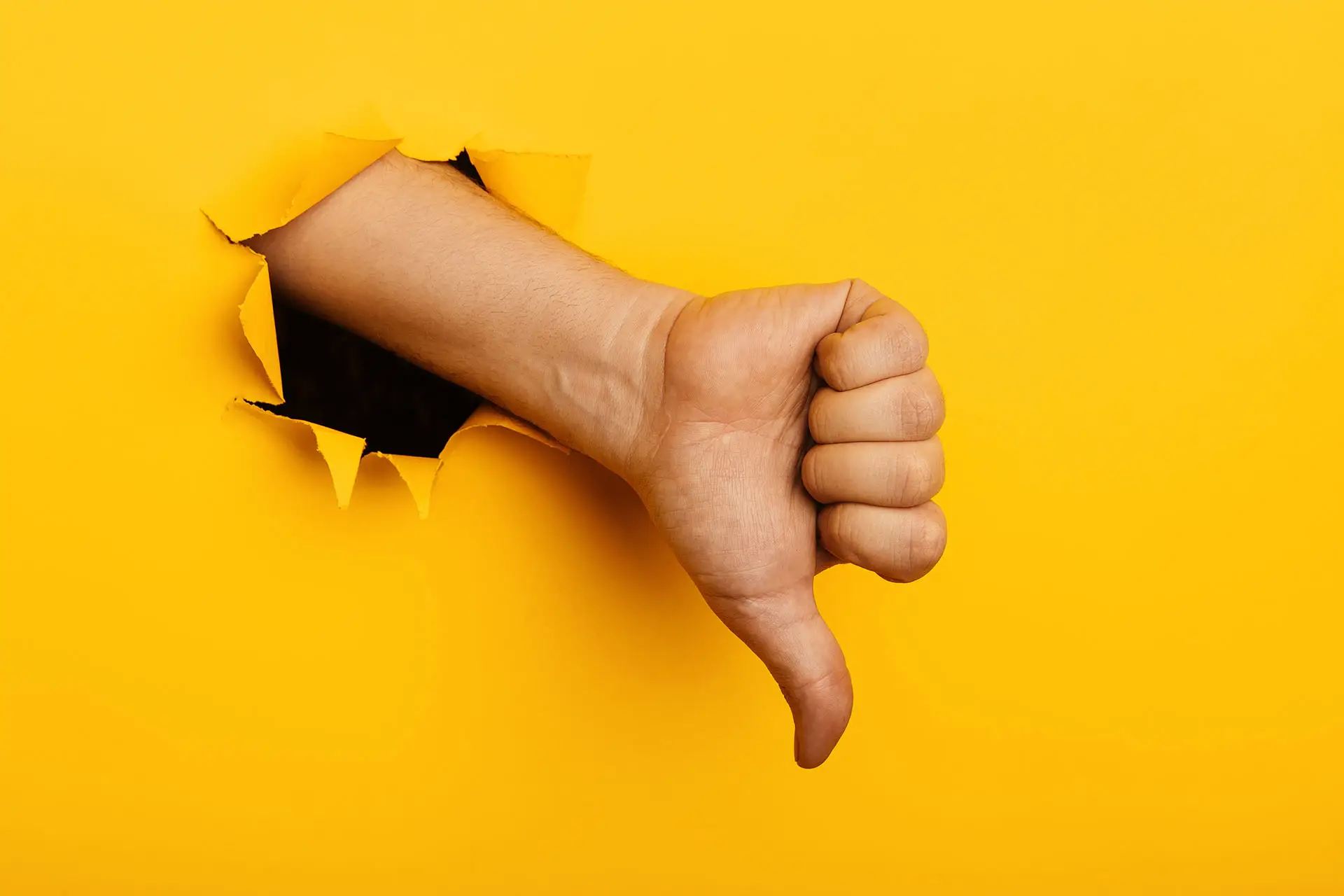 Social Media Warning image shows a thumbs down hand and arm coming out of a bright yellow paper wall