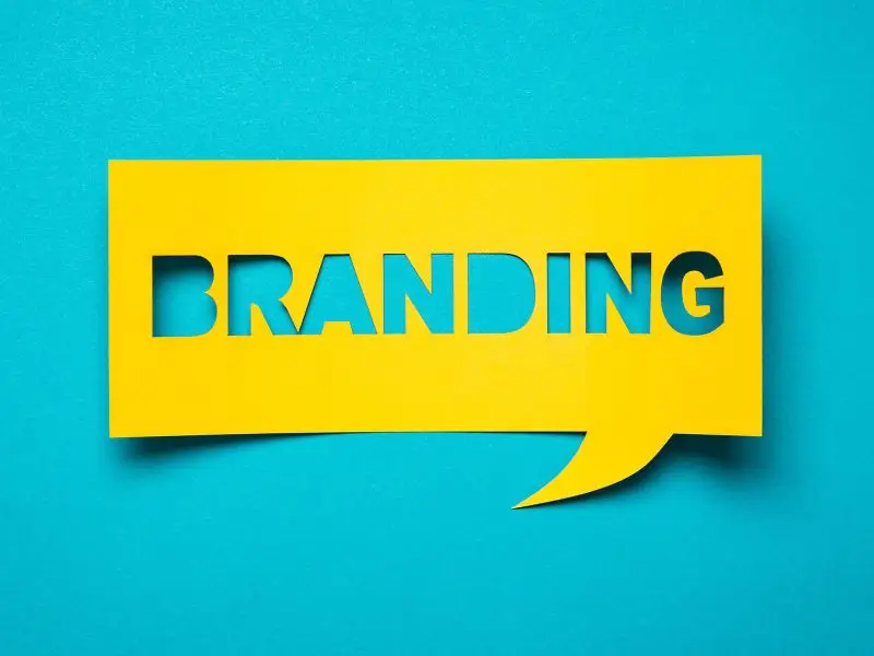 The Importance of Protecting Your Brand the image shows a bright blue background with a yellow cut out speech bubble that says branding