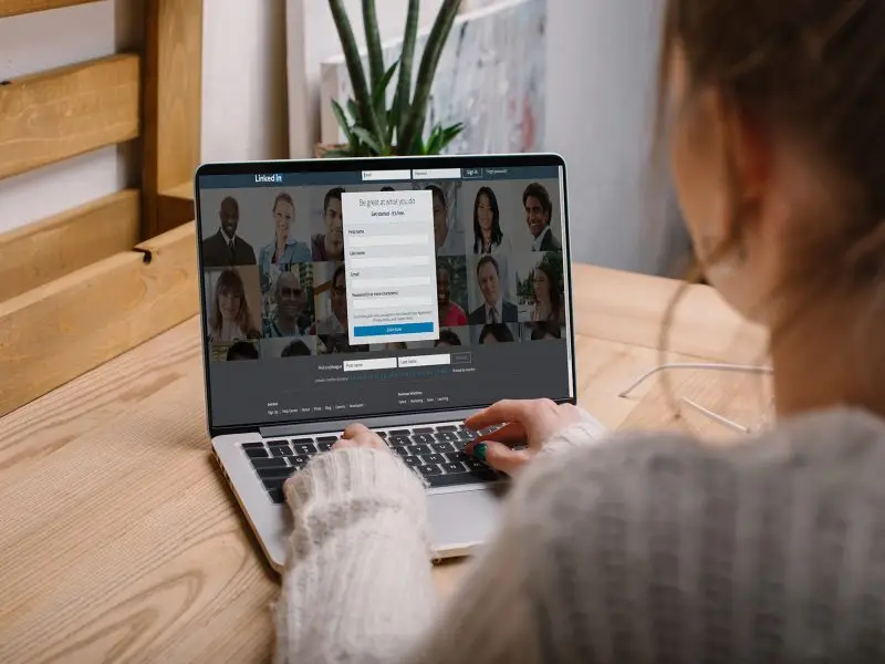 Why LinkedIn SWAM is Causing Concern this image shows a lady seated at her laptop about to login to LinkedIn