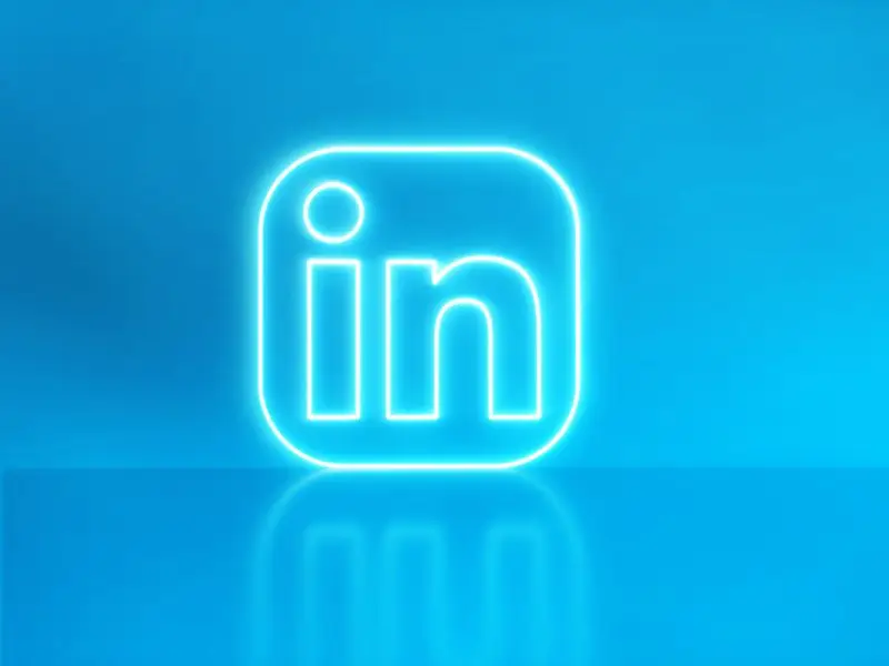 Are You Making the Most of LinkedIn Long Form Posts? This bright blue image shows a neon LinkedIn Icon button