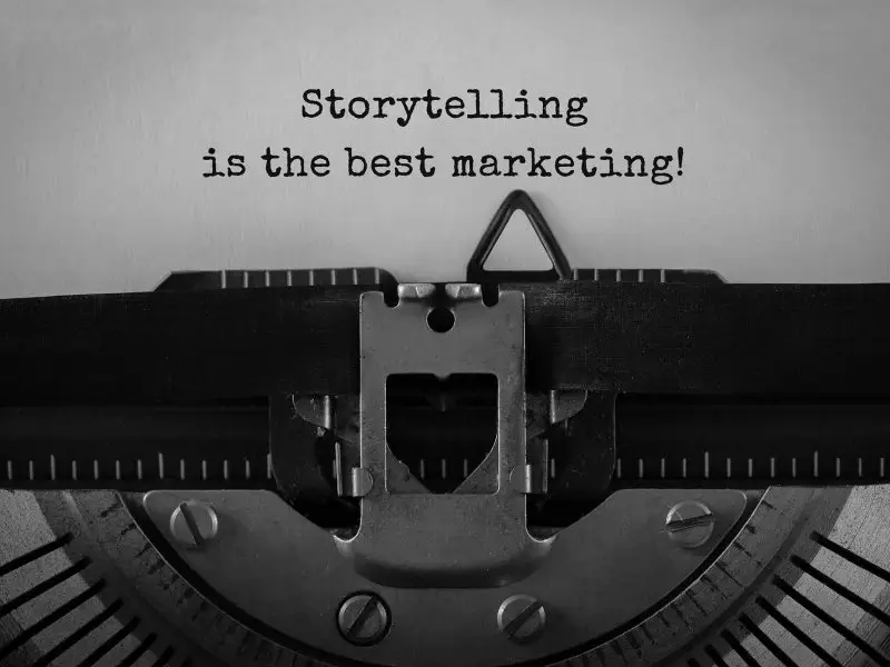 Tell a Story if You Really Want to Be Remembered - this image shows a black and white close up of a typewriter, the ribbon and sheet of paper, on the sheet are the typed words "Storytelling is the best marketing!"