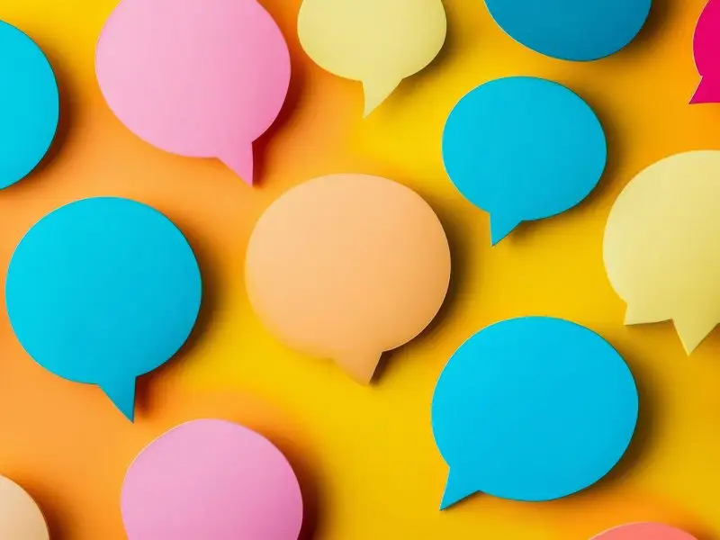 A Few More Social Media Marketing Tips - this image shows a bright yellow background with multicoloured speech bubbles - social marketing concept