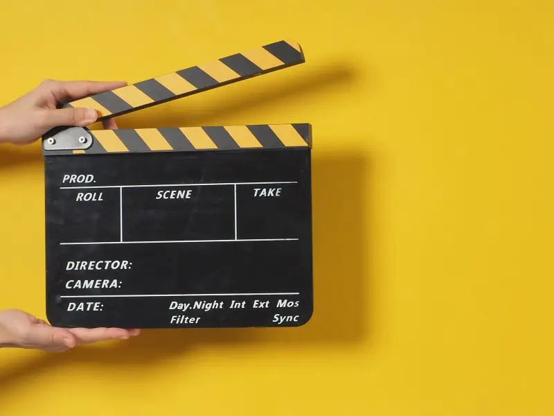 Busting The Video SEO Myth - this image shows a bright yellow background with a video clip board in the foreground