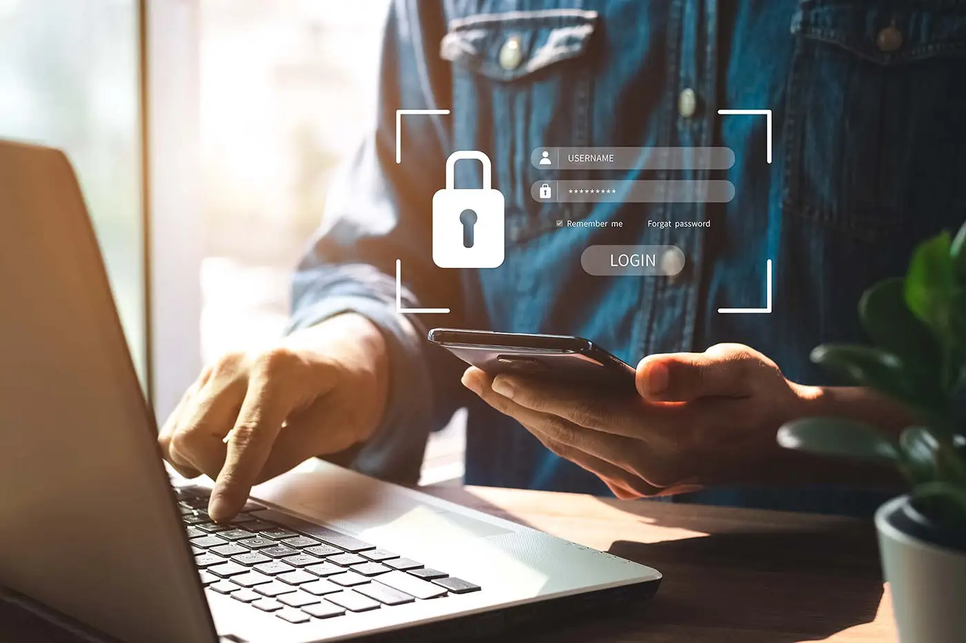 Protecting Your WordPress Website - this image shows a person sat at a laptop with a mobile device in their hand. Above the mobile is a graphic with a padlock, denoting secure site logins