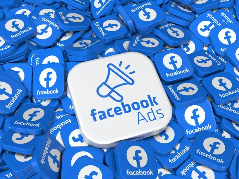 Successful Facebook Adverts this image is of a pile of tiles all with Facebook icons on them, in the centre is a large white tile with a megaphone and Facebook Ads