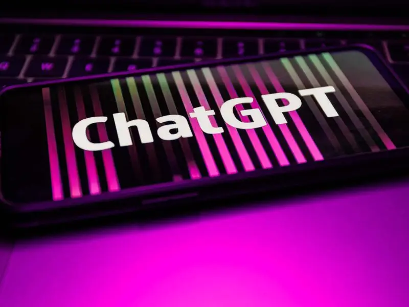 What is ChatGPT? This image shows a bright pink background with a mobile device with the wording ChatGPT on it