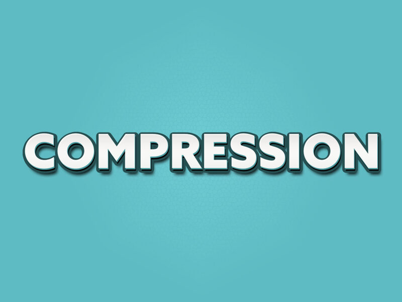 This image shows a pale teal blue background with the word compression in white, bold and shadowed